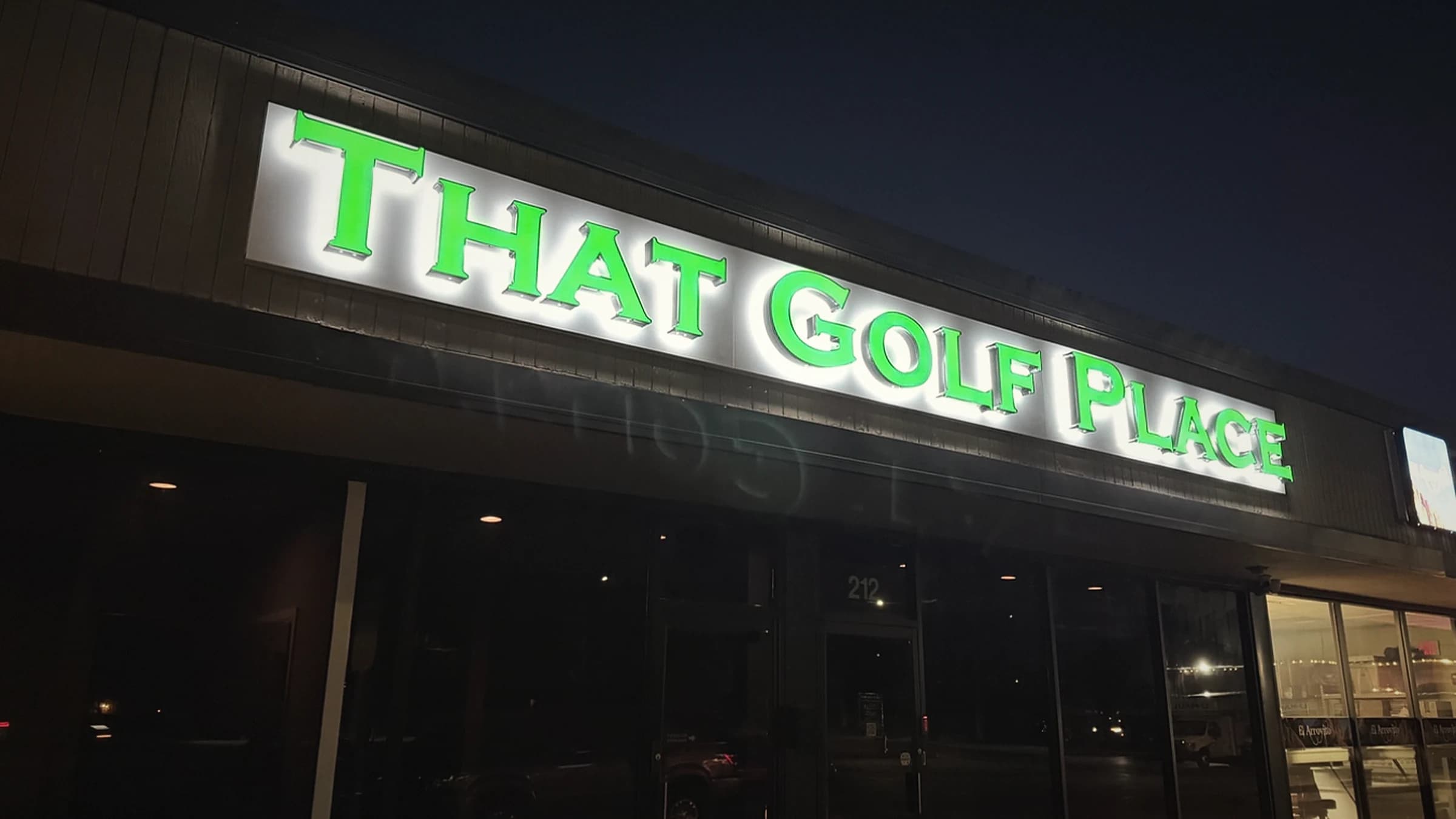 That Golf Place storefront sign at twilight, 212 E. Chicago Ave., Westmont, IL